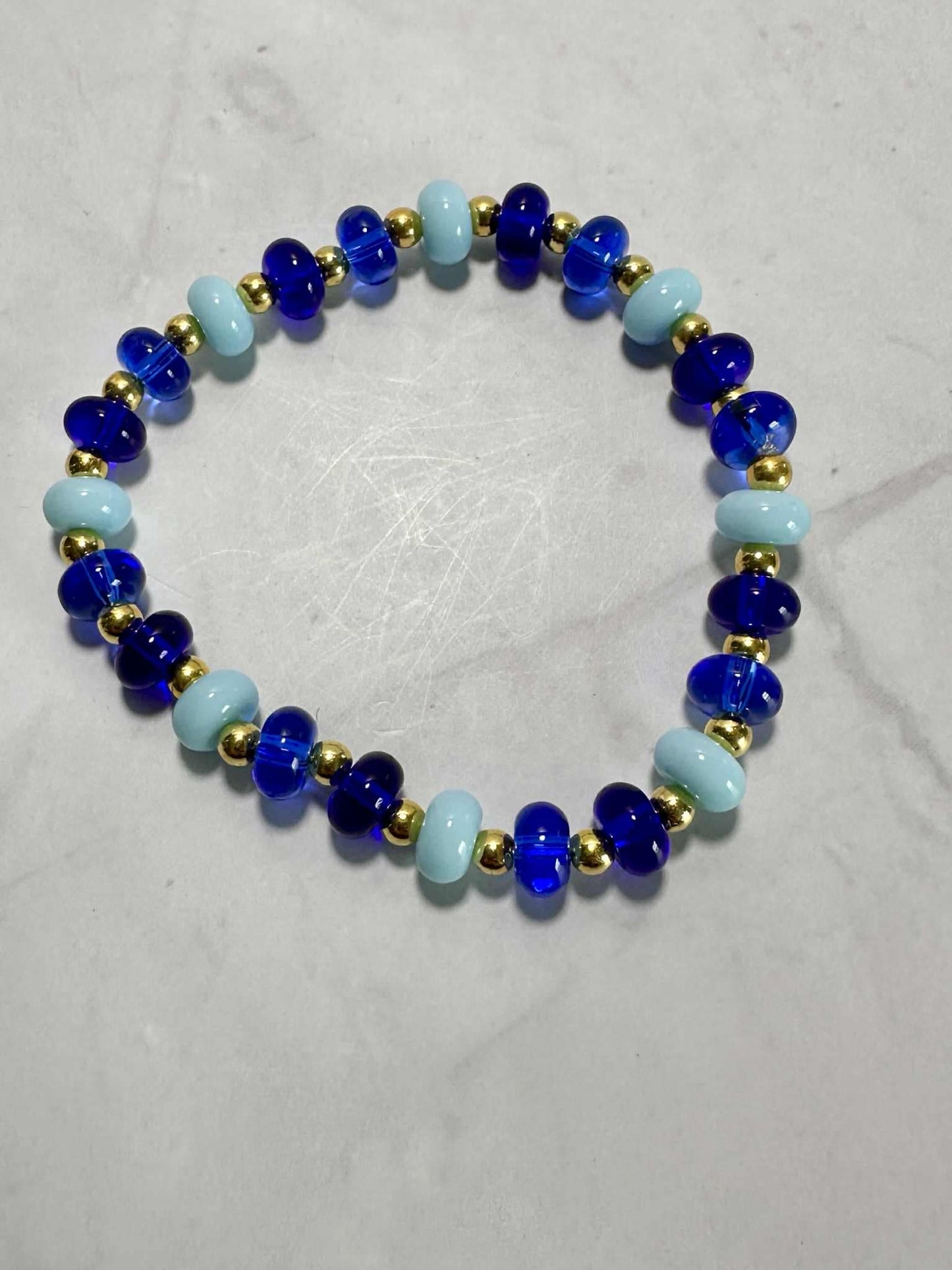 Single Strand Blue Ocean Glass Beaded Stretch Bracelet: Gold Accents