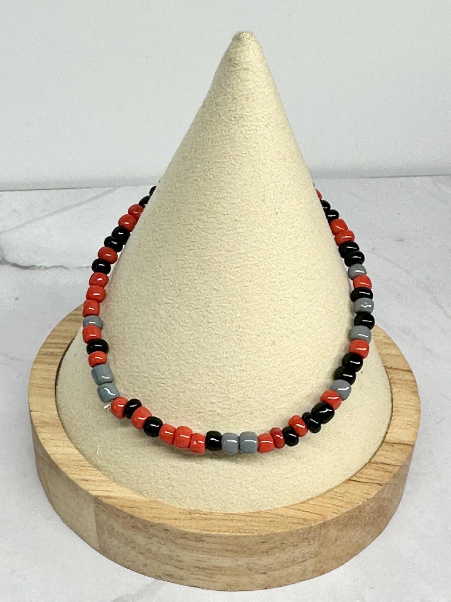 Single Strand Red, Black, and Gray Seed Bead Stretch Bracelet