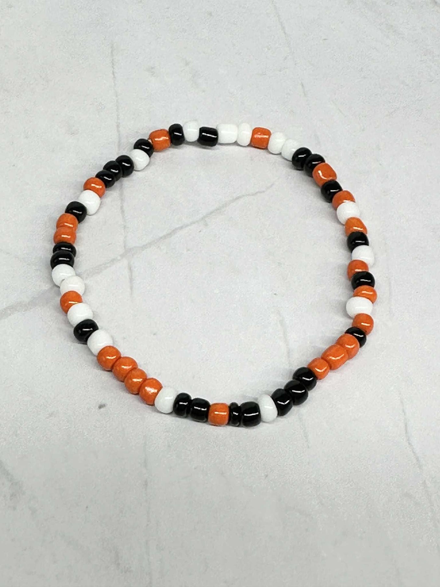 Single Strand Orange, Black and White Seed Bead Stretch Bracelet