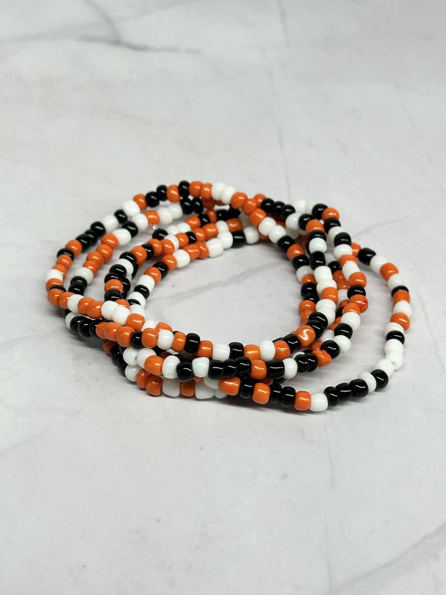 Single Strand Orange, Black and White Seed Bead Stretch Bracelet