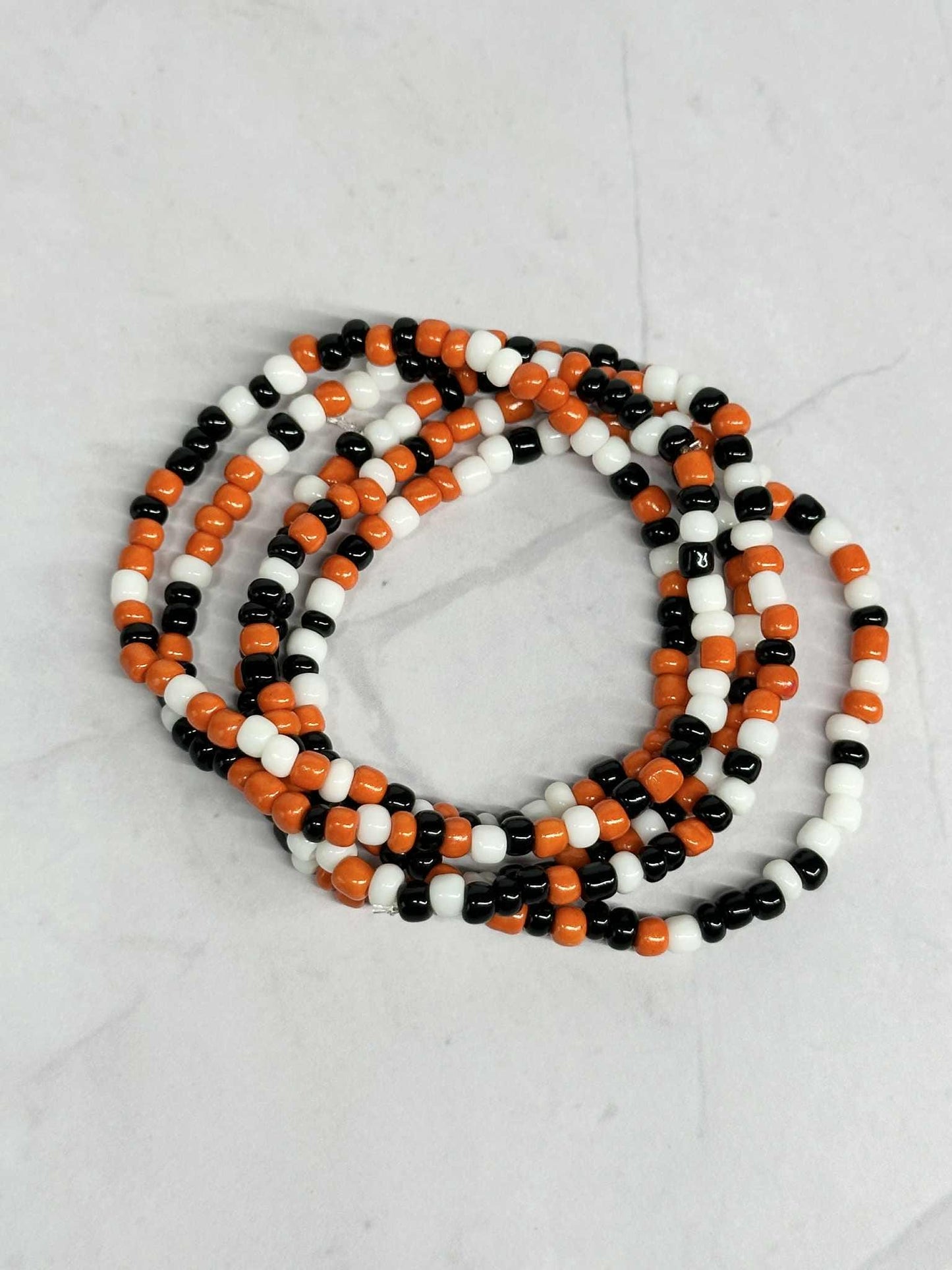 Single Strand Orange, Black and White Seed Bead Stretch Bracelet
