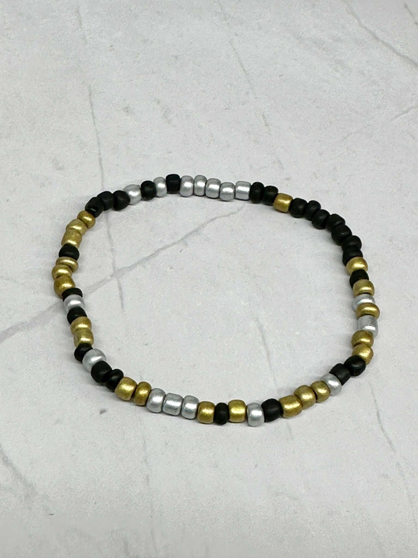 Single Strand Silver, Black, and Gold Seed Bead Stretch Bracelet