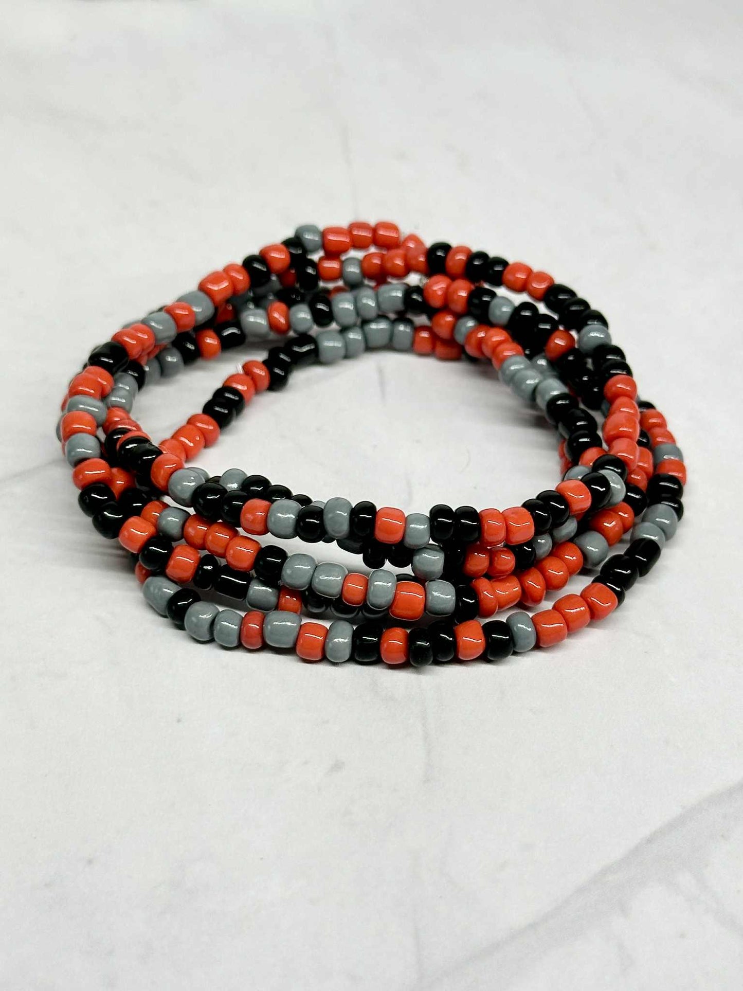 Single Strand Red, Black, and Gray Seed Bead Stretch Bracelet