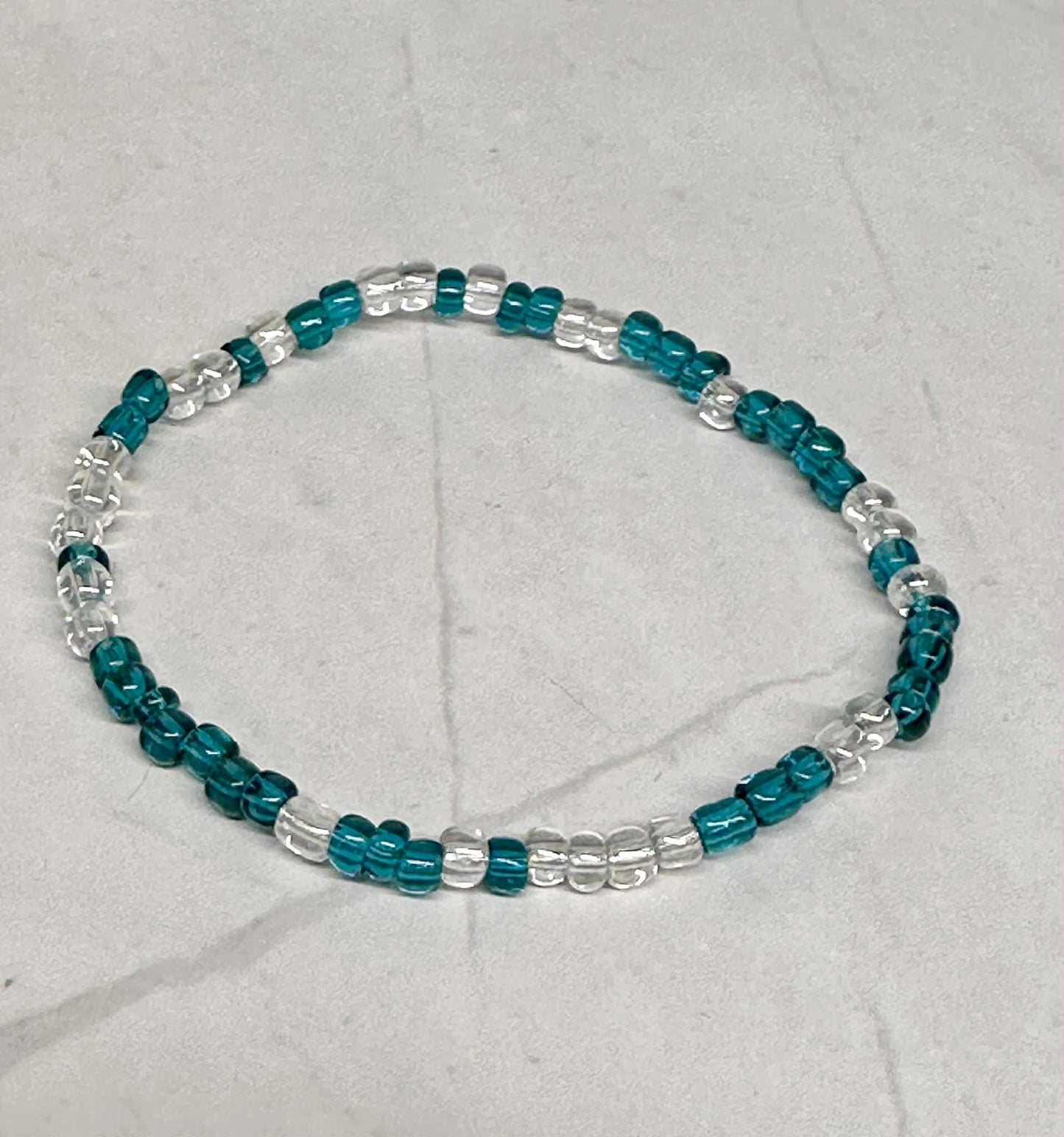 Single Strand Translucent Turquoise/Clear Seed Bead Bracelet