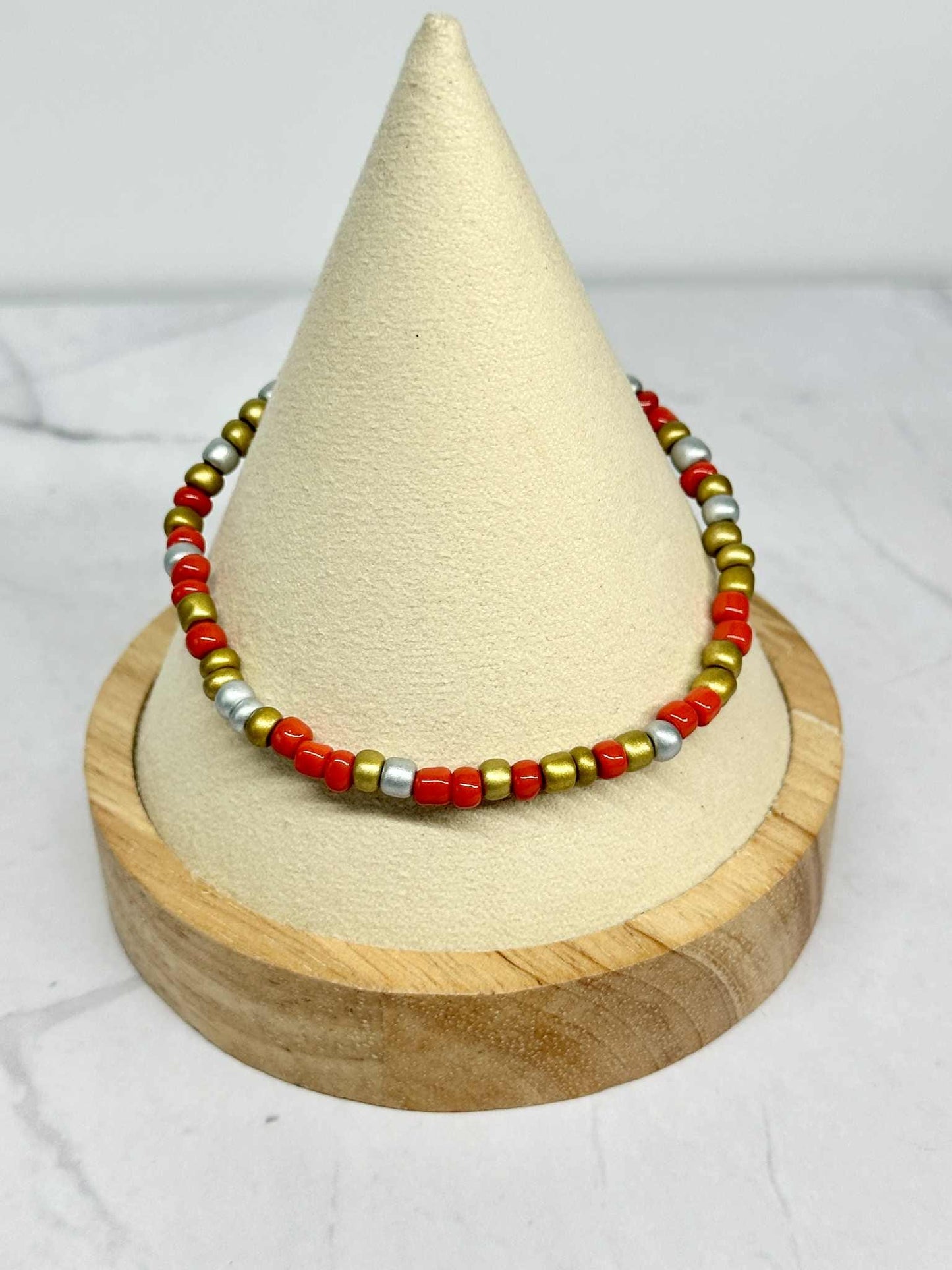 Single Strand Red, Silver, and Gold Seed Bead Stretch Bracelet