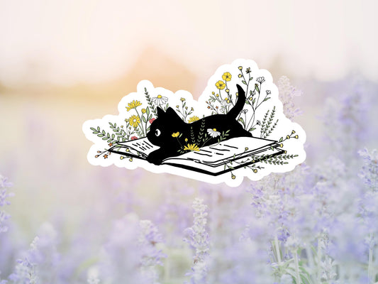 Black Cat Lying On Open Book With Wildflowers Sticker
