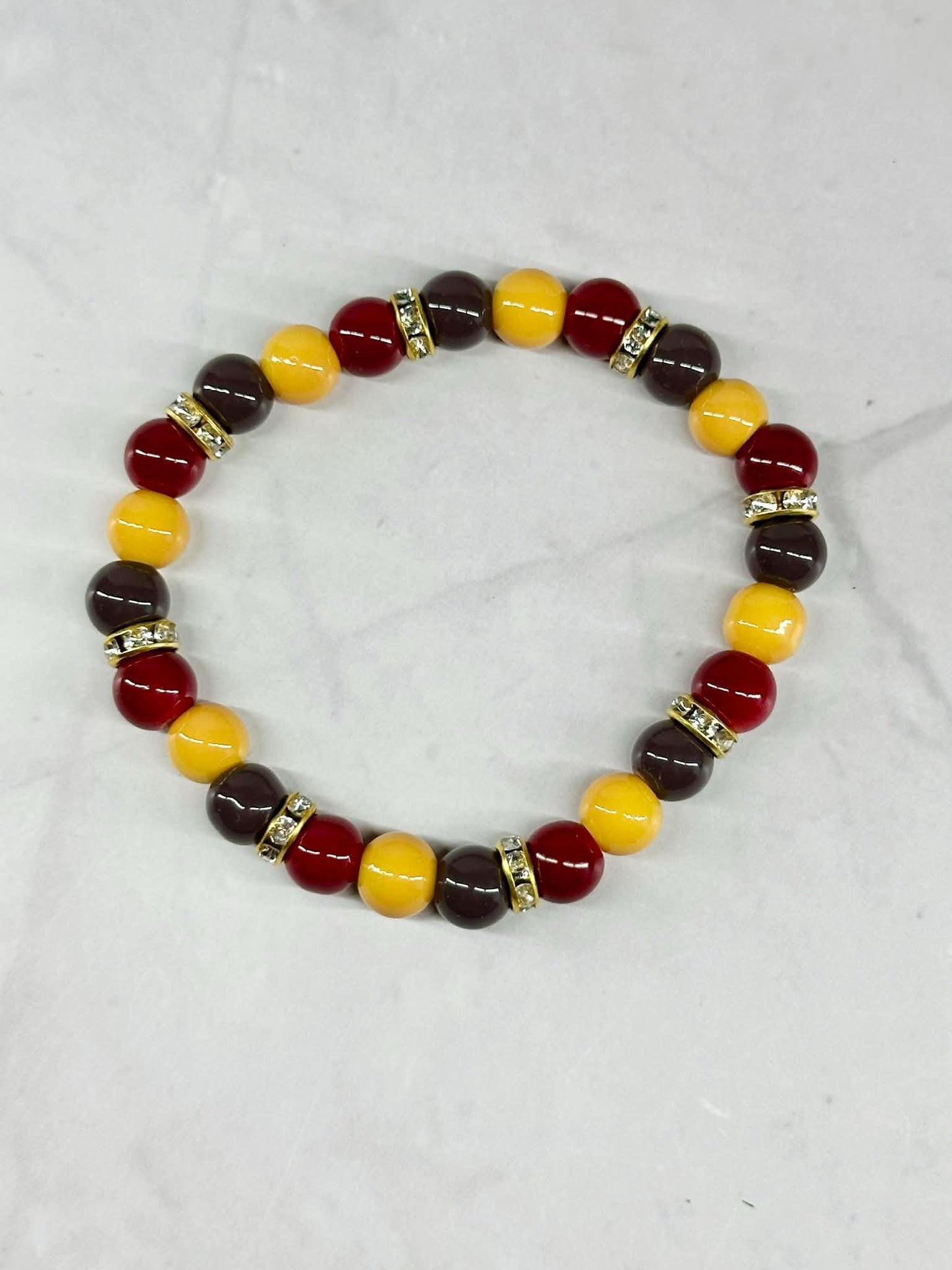 Single Strand Yellow, Red, and Brownish/Gray Beaded Stretch Bracelet