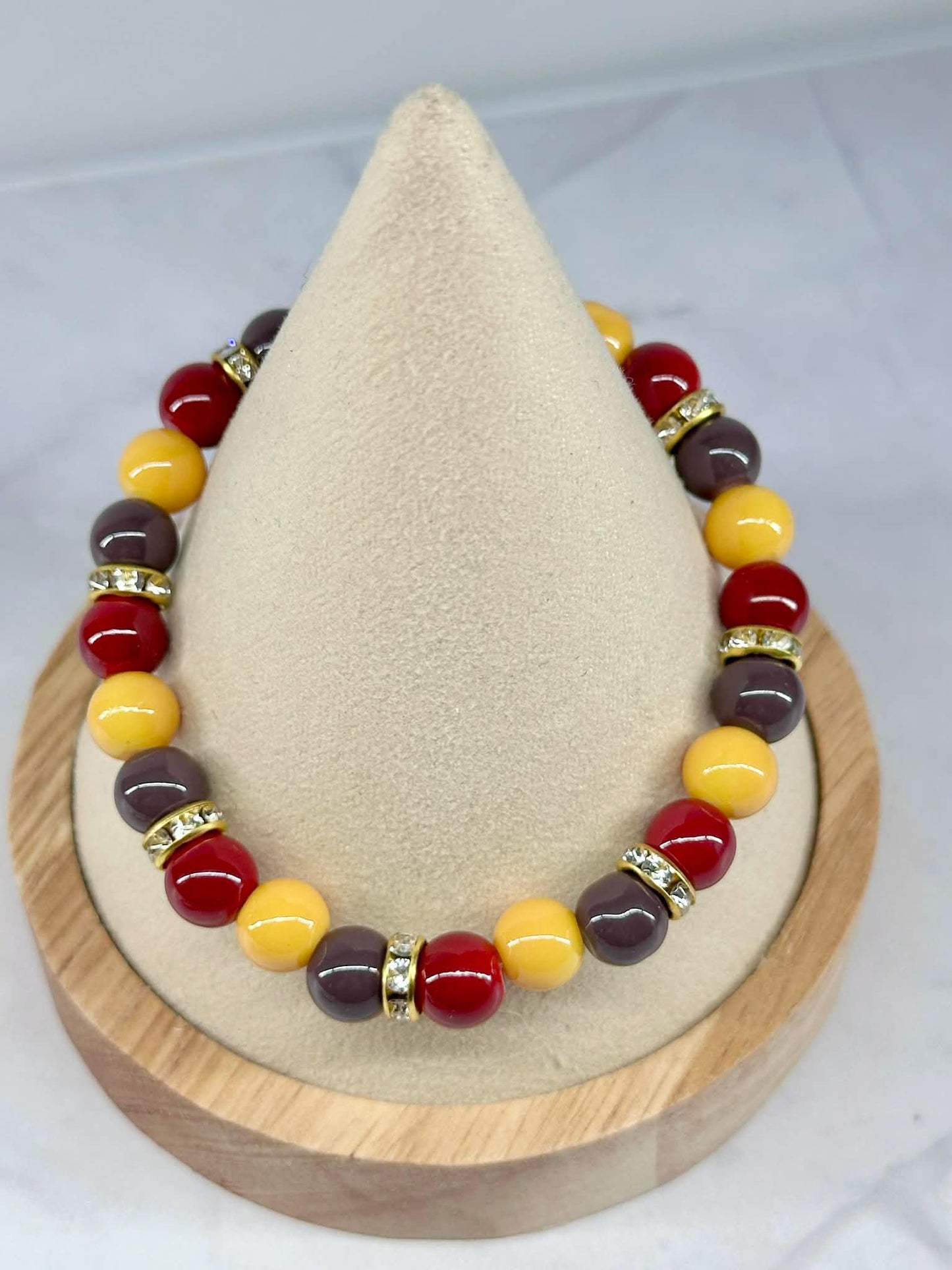 Single Strand Yellow, Red, and Brownish/Gray Beaded Stretch Bracelet
